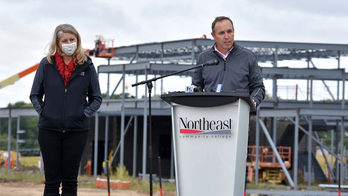 Trevor Jones, Public Affairs Advisor for TC Energy, right, and Dr. Tracy Kruse, Associate Vice President of Development and External Affairs, Northeast Community College, discuss TC Energy's US$500,000 donation as construction progresses on a new agricultural center in the background.